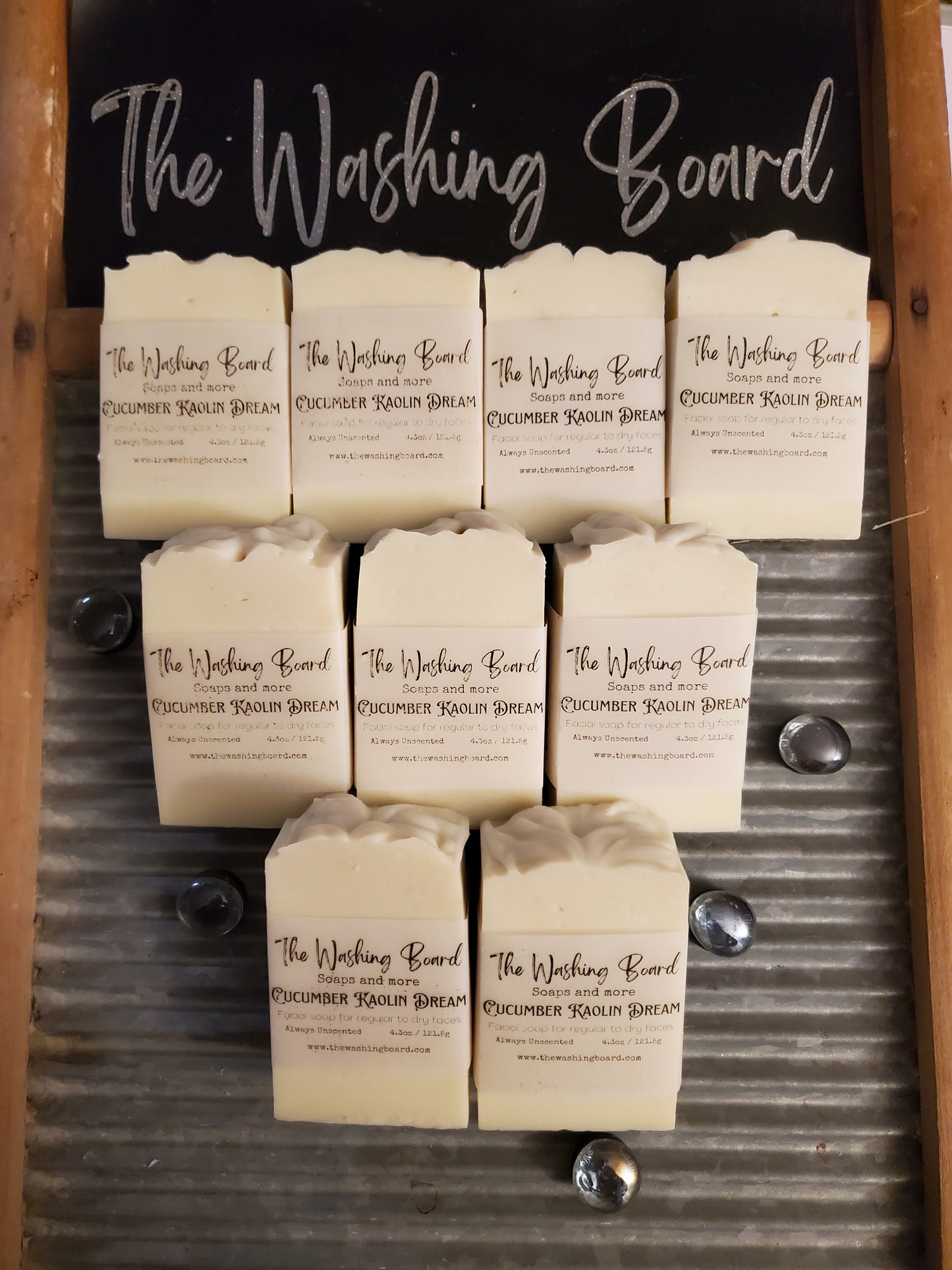 Cucumber Kaolin Dream soap bars lined up on a wash board.