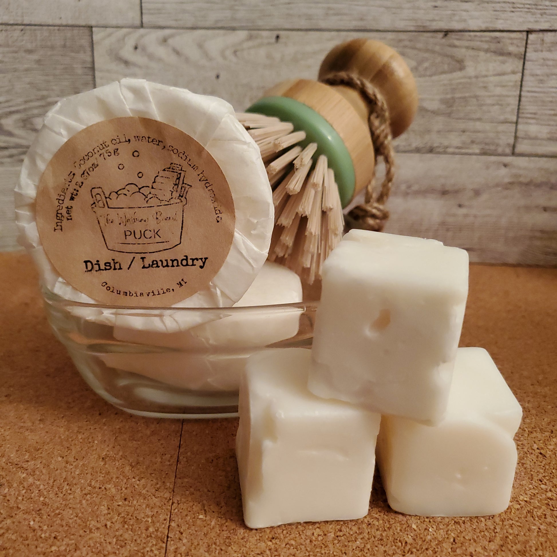 Scrubby Dish Brush shown in a dish with Dish and Laundry pucks and cubes.