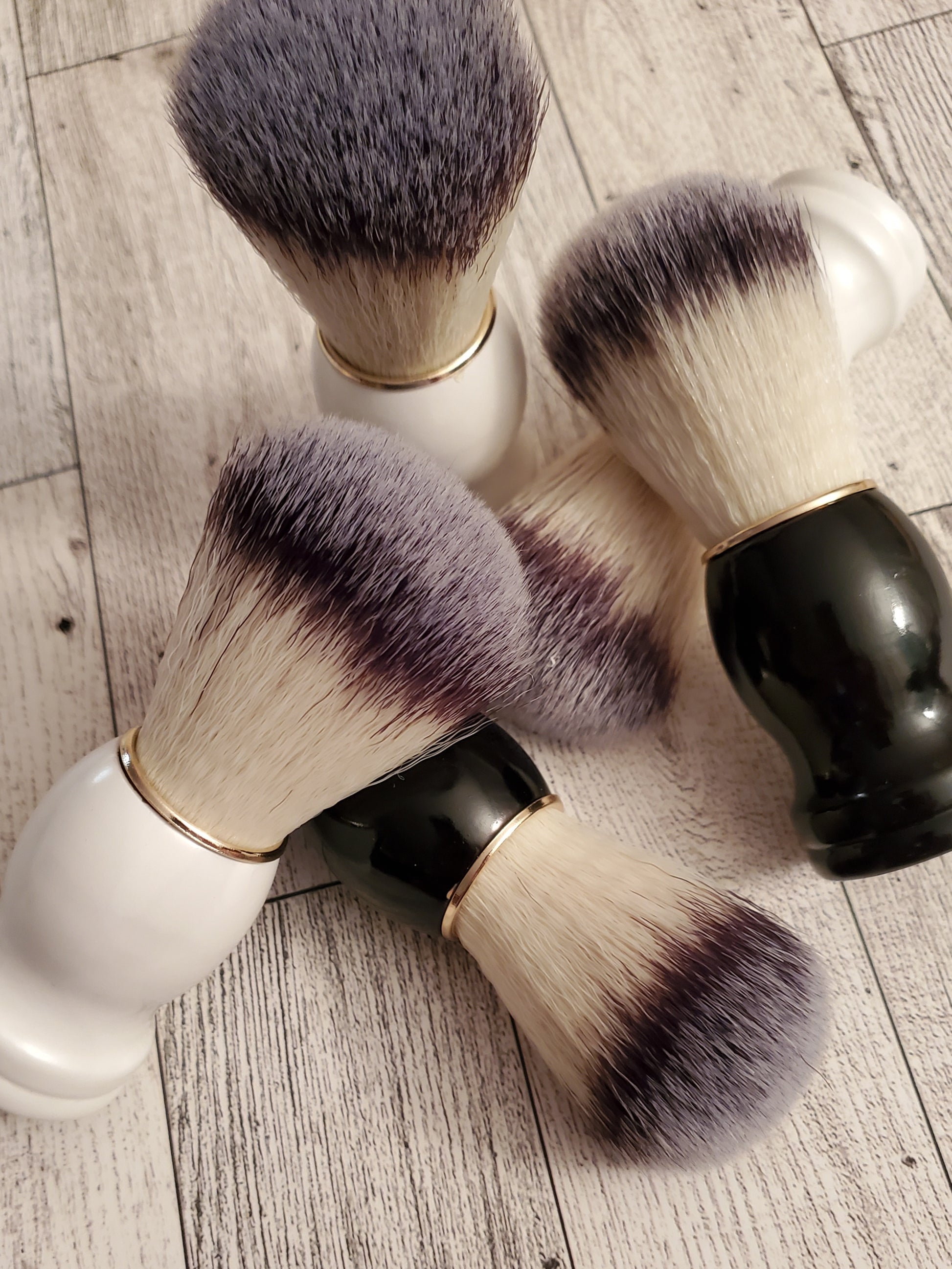 Shave Brushes, black and white handles, together.