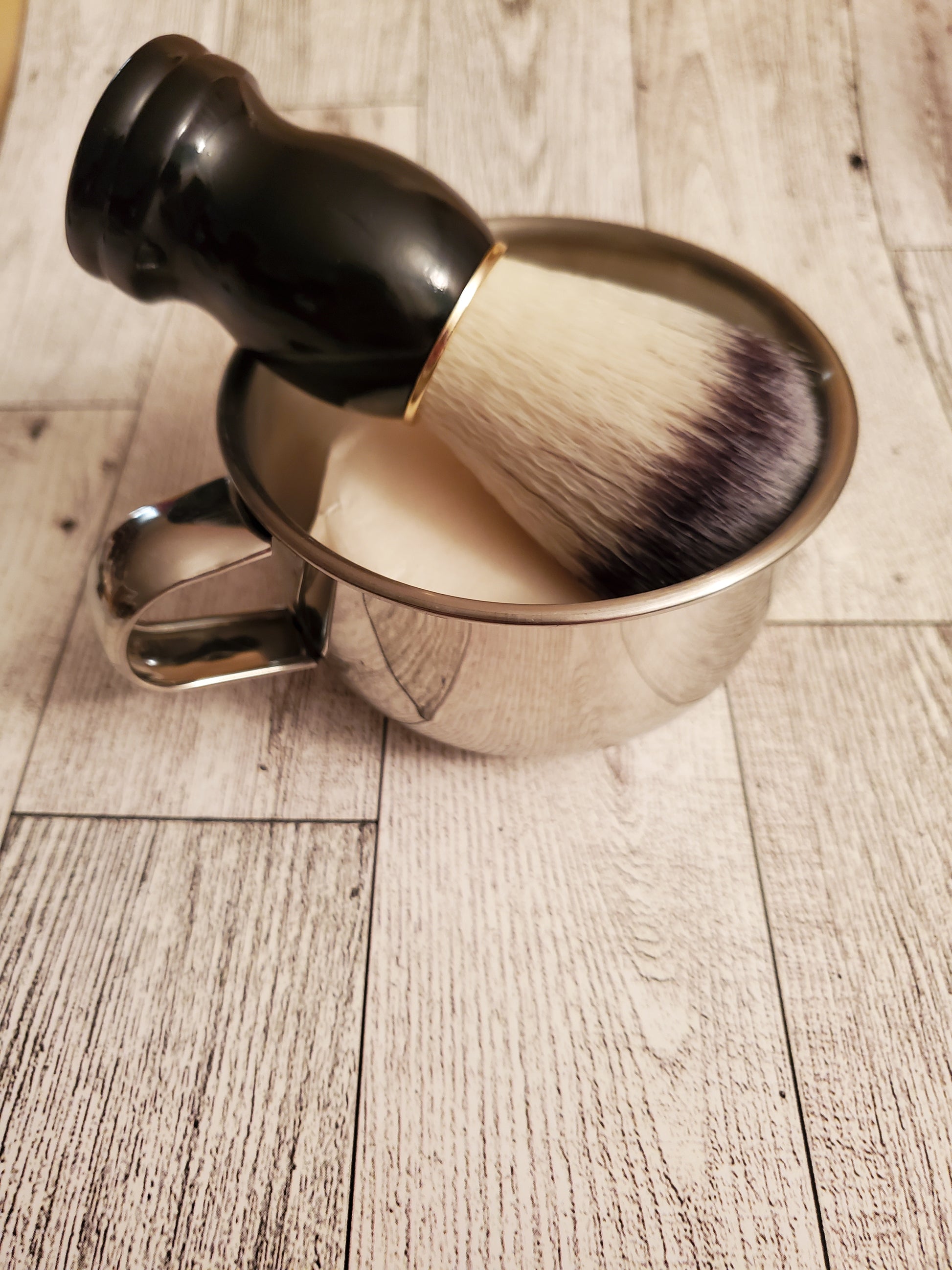 Shave Bowl, stainless steel, shown with Shave Brush black handle and a puck of Shave Soap.