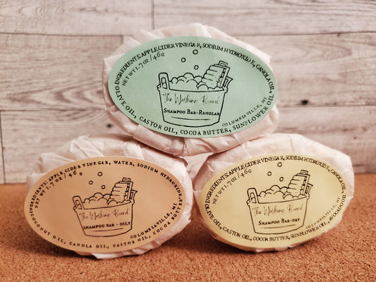 Shampoo bars, oily, regular and dry, shown together in eco friendly packaging.