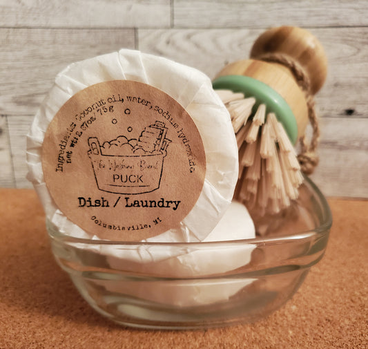2 Dish and Laundry Pucks shown with Scrubby Dish Brush in a dish.