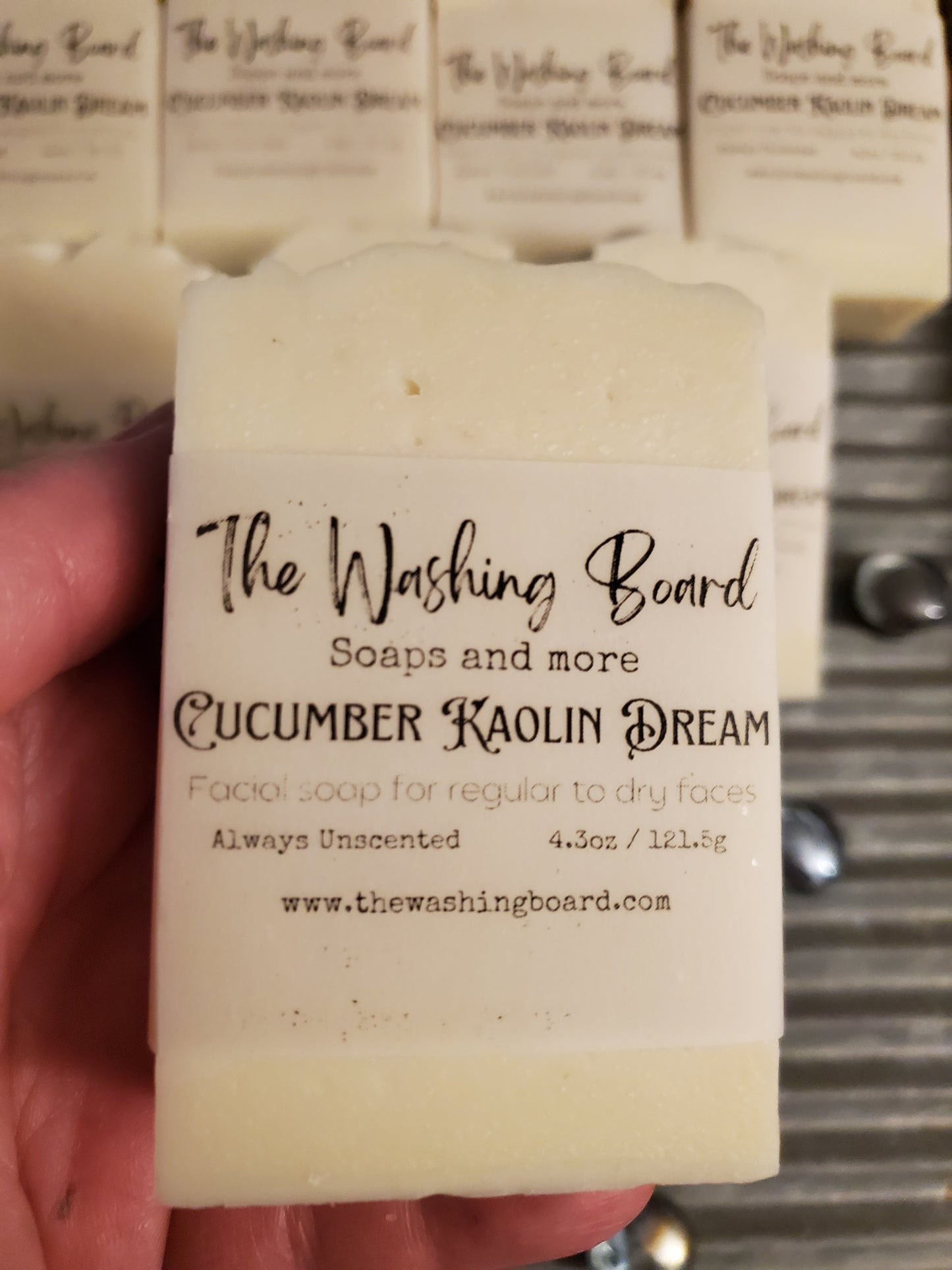 Cucumber Kaolin Dream being held by a woman's hand above a wash board.