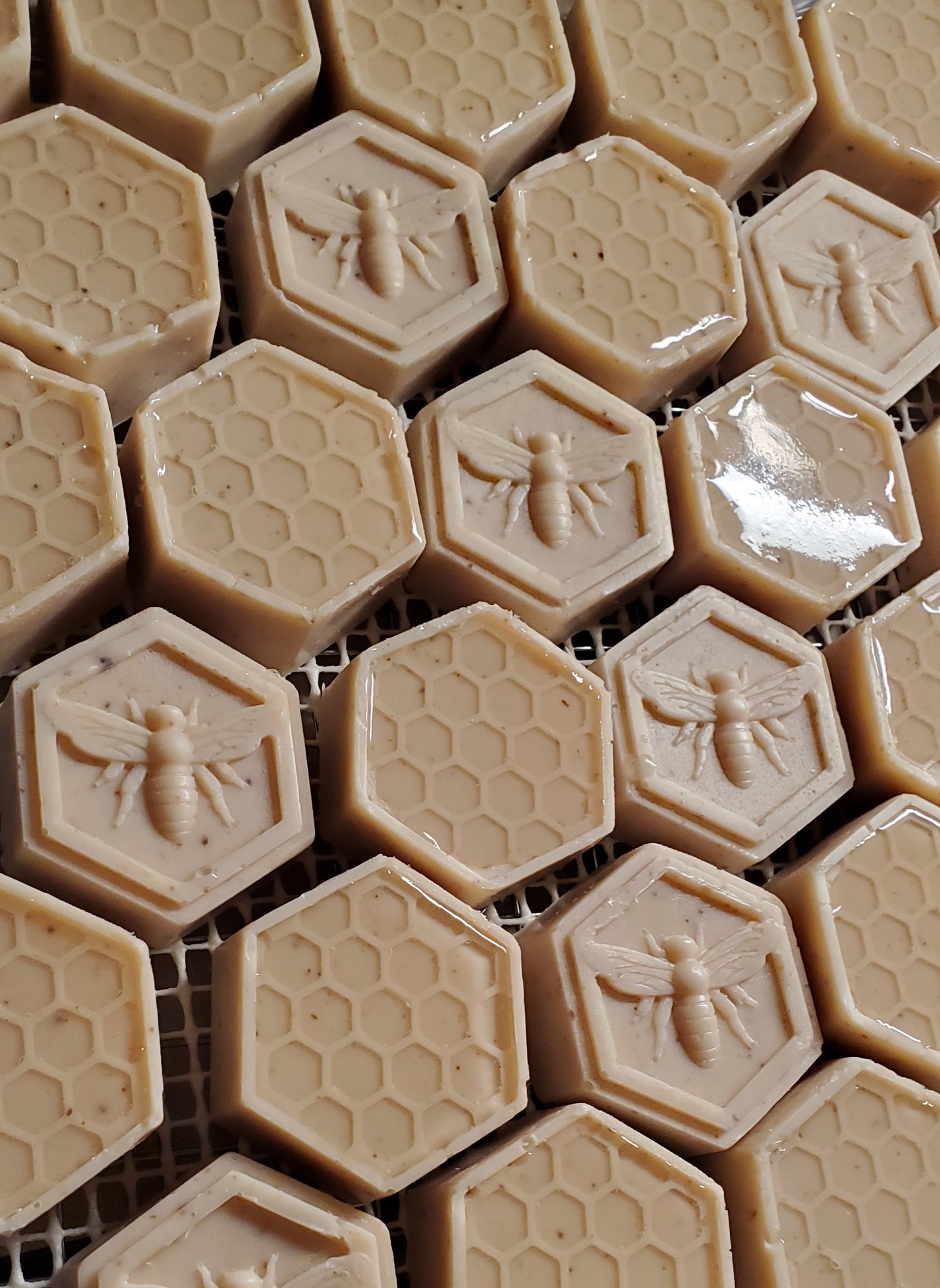 Bee Happy honeycomb edition shown with many bars together, with both honeycomb look and bee topped hexagon shapes. 