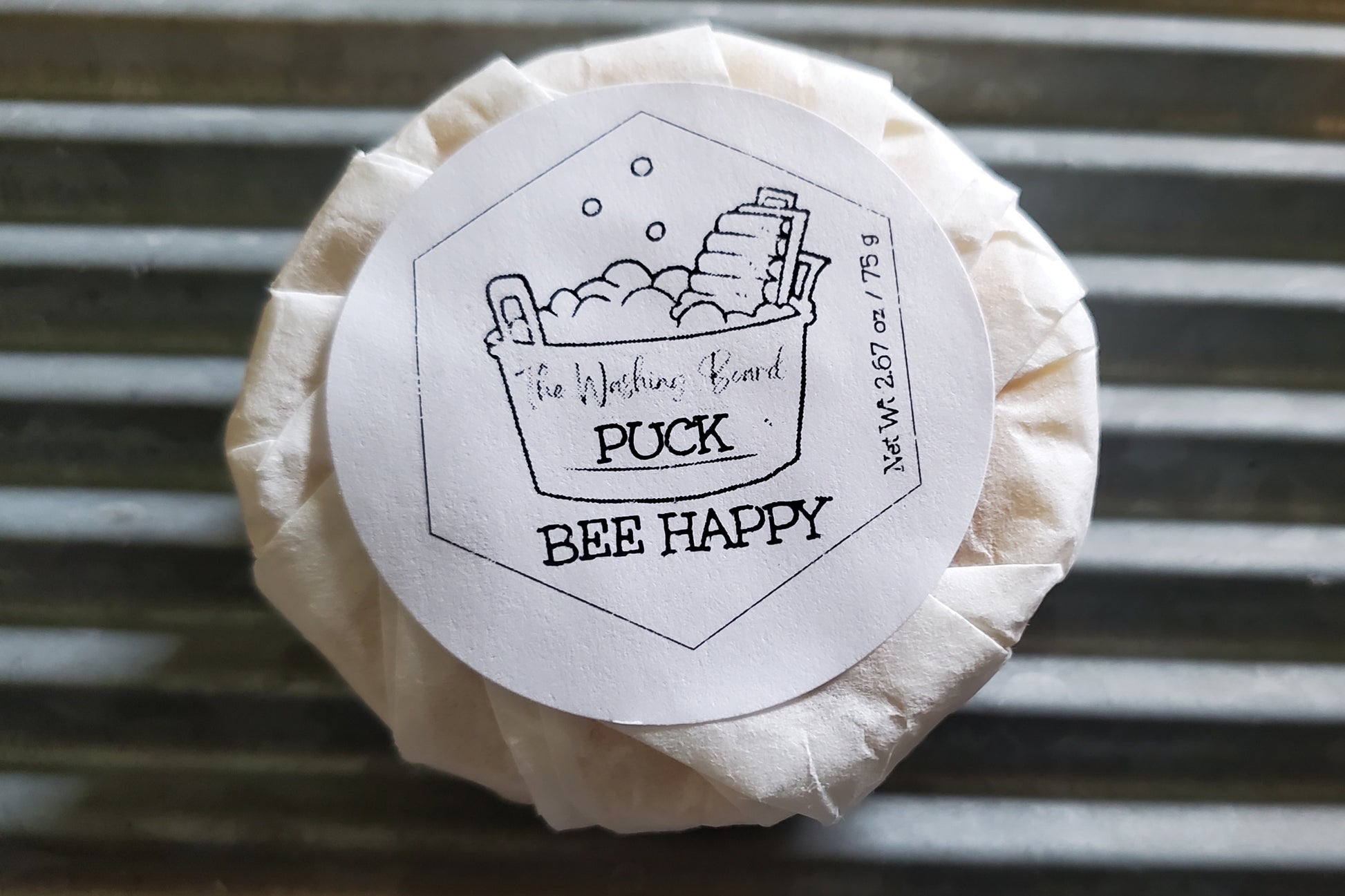 Bee Happy puck shown with label and eco friendly packaging