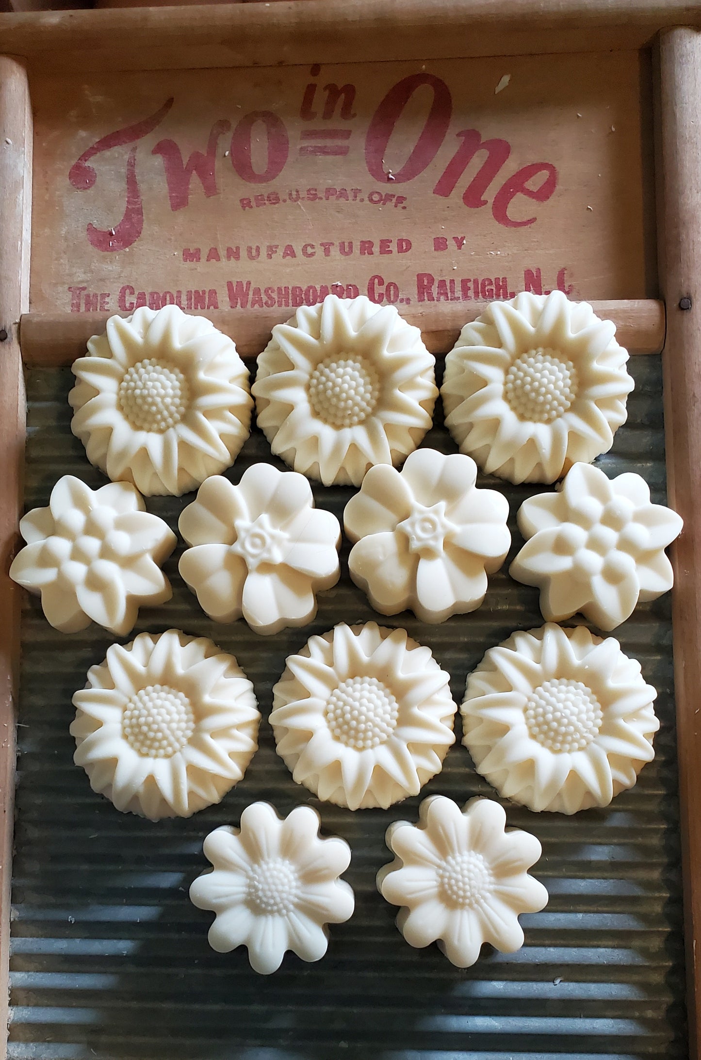 Just Plain floral edition soaps shown on a washing board. 