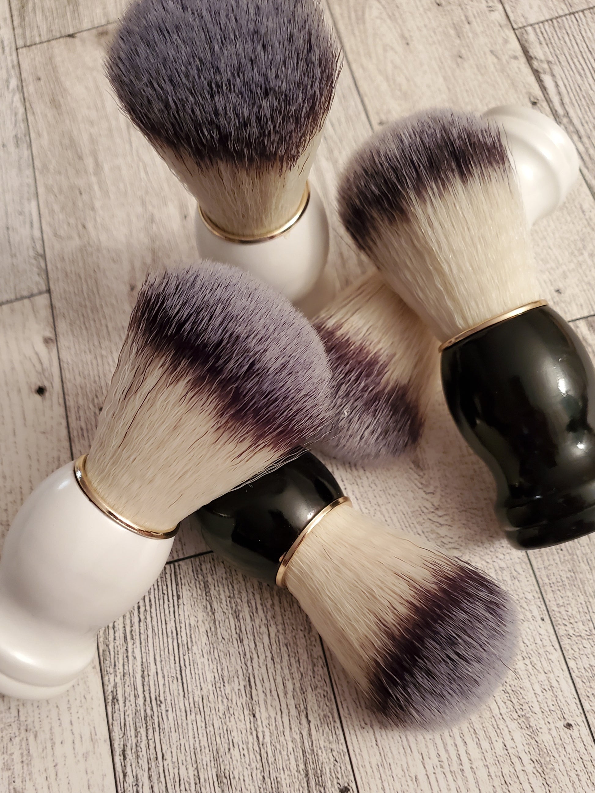 Shave Brushes, black and white handles, together.   