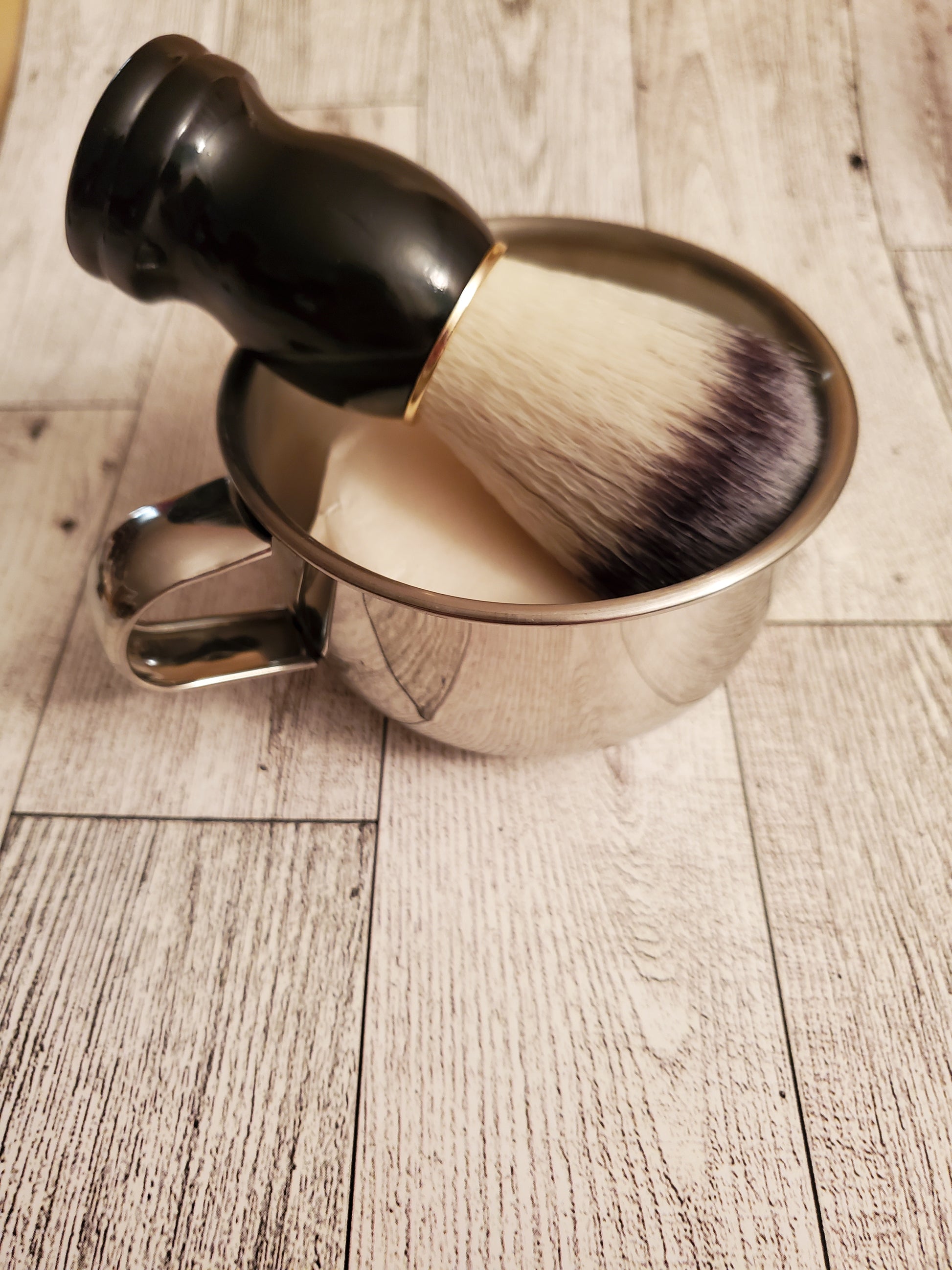 Shave Bowl, stainless steel, shown with Shave Brush black handle and a puck of Shave Soap. 