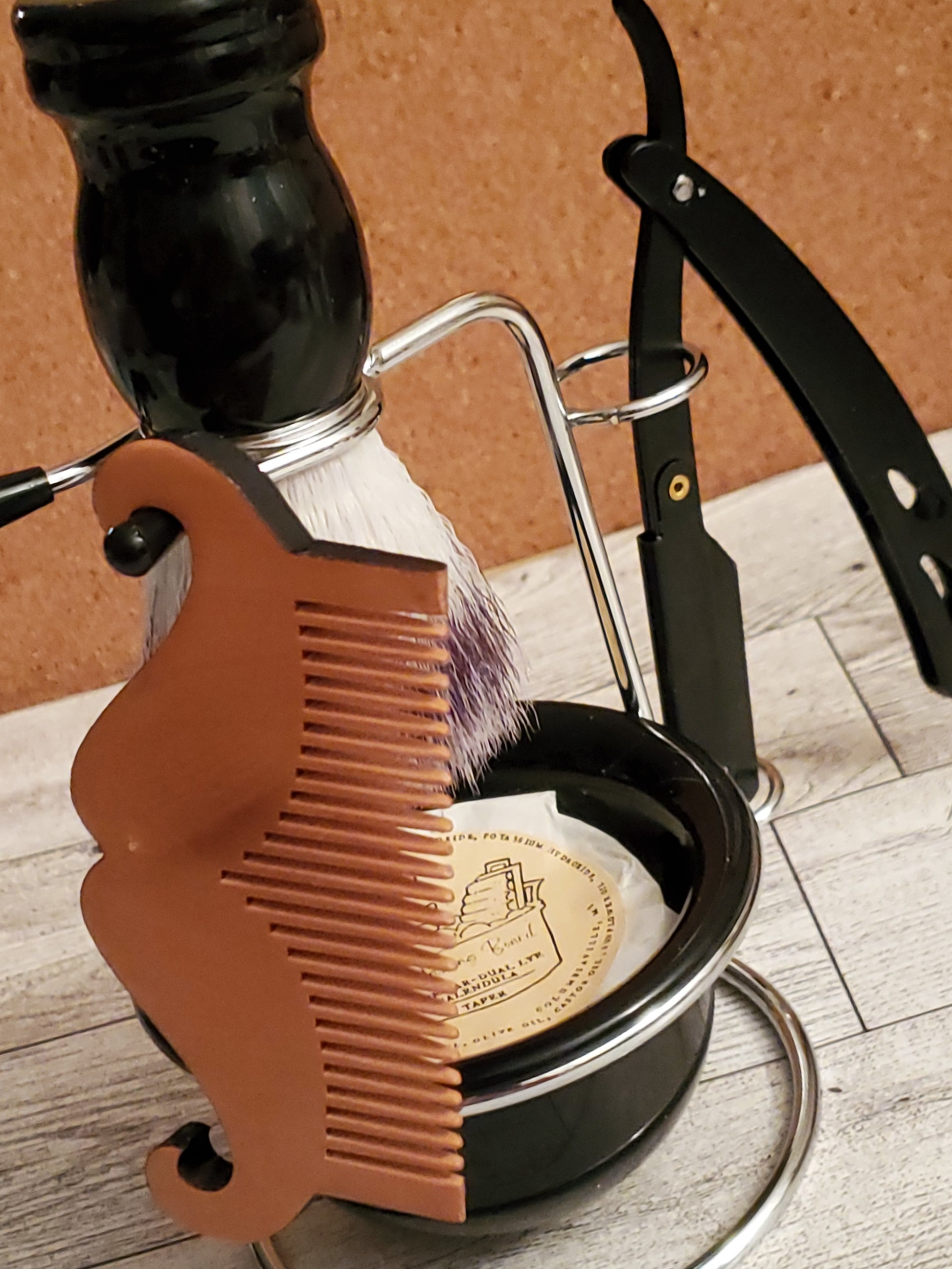 Mustache Comb shown on a shaving kit stand with bowl, Shaving Soap Dual Lye taper , and black shaving brush.  